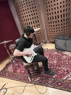 teenage boy playing bass guitar