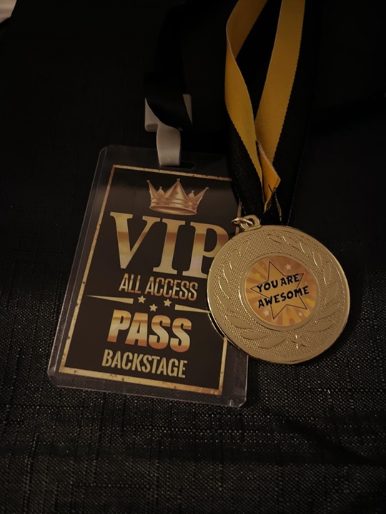 A vip pass and a gold medal