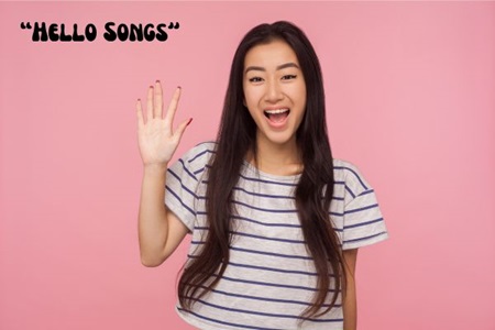 Young lady with long black hair wearing a stripy t-shirt waving