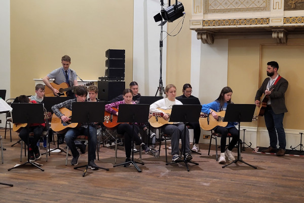 Group of students playing guitars