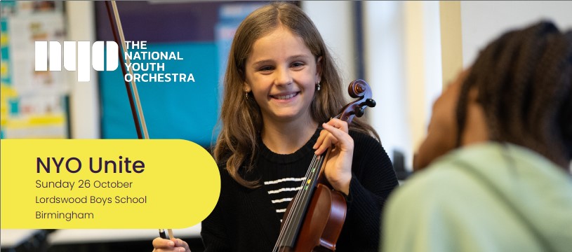 Girl holding a violin and smiling