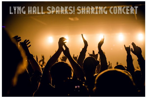 Silhouetted people cheering and waving at a concert with bright yellow lights on a stage