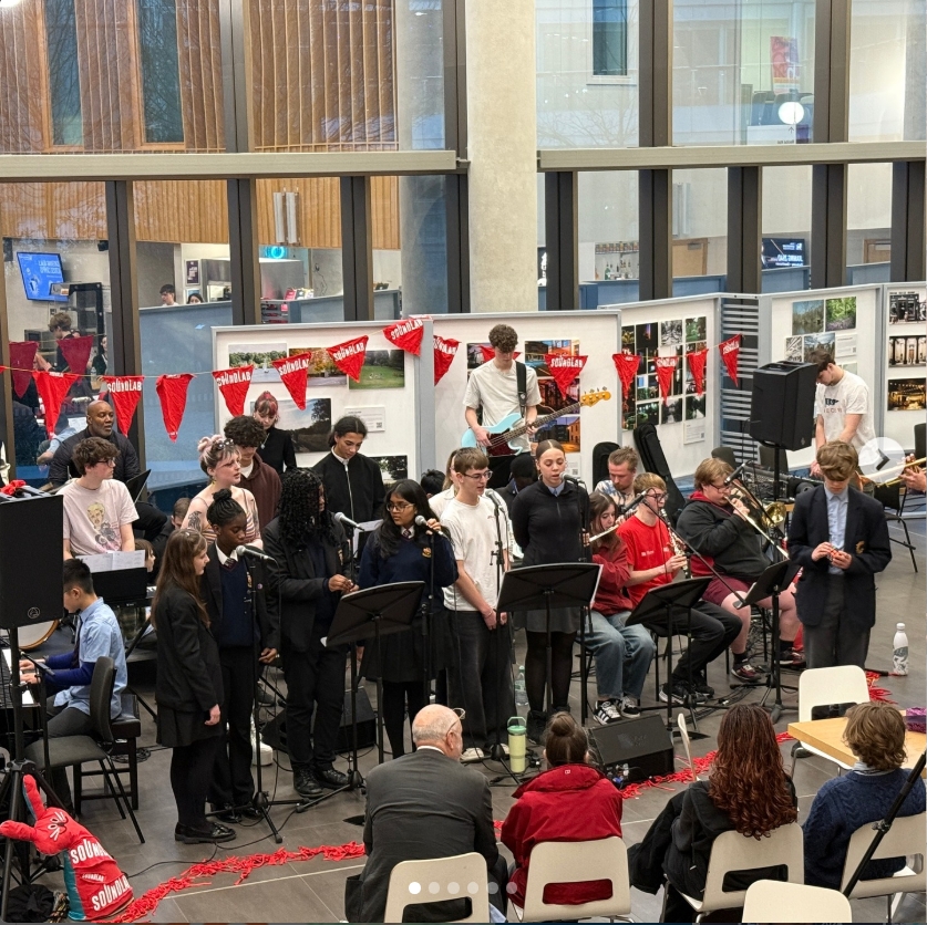 group of young adult musicians performing together live at a venue