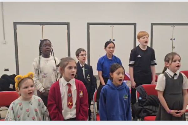 primary aged children singing in a choir